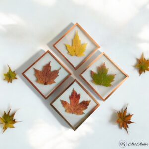 A vibrant collection of colorful glass coasters in blue, green, and amber, arranged neatly on a marble countertop