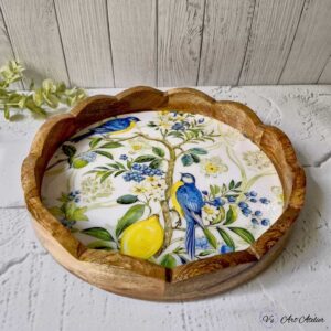 Decorative round wooden serving tray with candles and décor