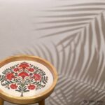 Round wooden side table with cross base