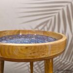 Side table with ceramic vase and design books