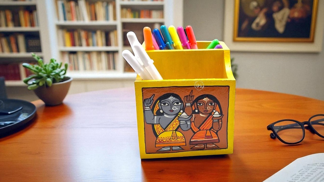 A collection of various handmade pen stands on a wooden table, showcasing a range of styles and materials.